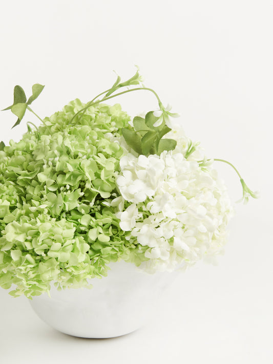 White Ceramic Vase with White and Green Snowball Flowers